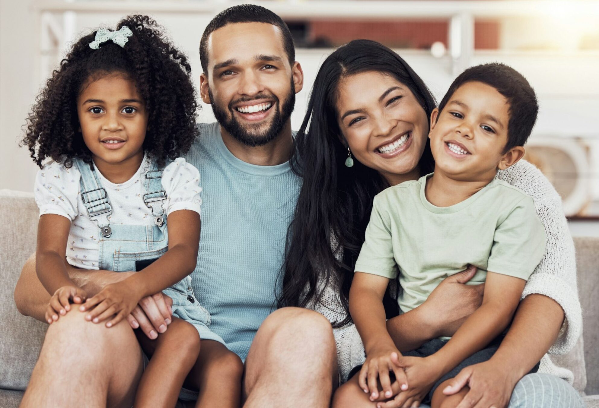 Happy, smile and portrait of a family bonding and relaxing together at home in puerto rico. Happine