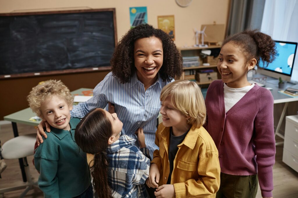 Female teacher with diverse group of little children