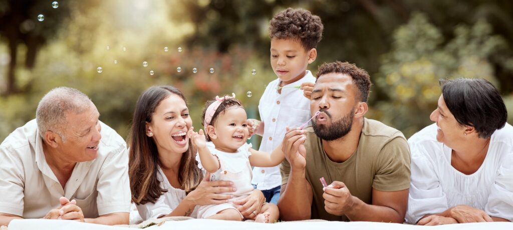 Happy, smile and big family blowing bubbles in a garden on a summer picnic in Puerto Rico. Happines