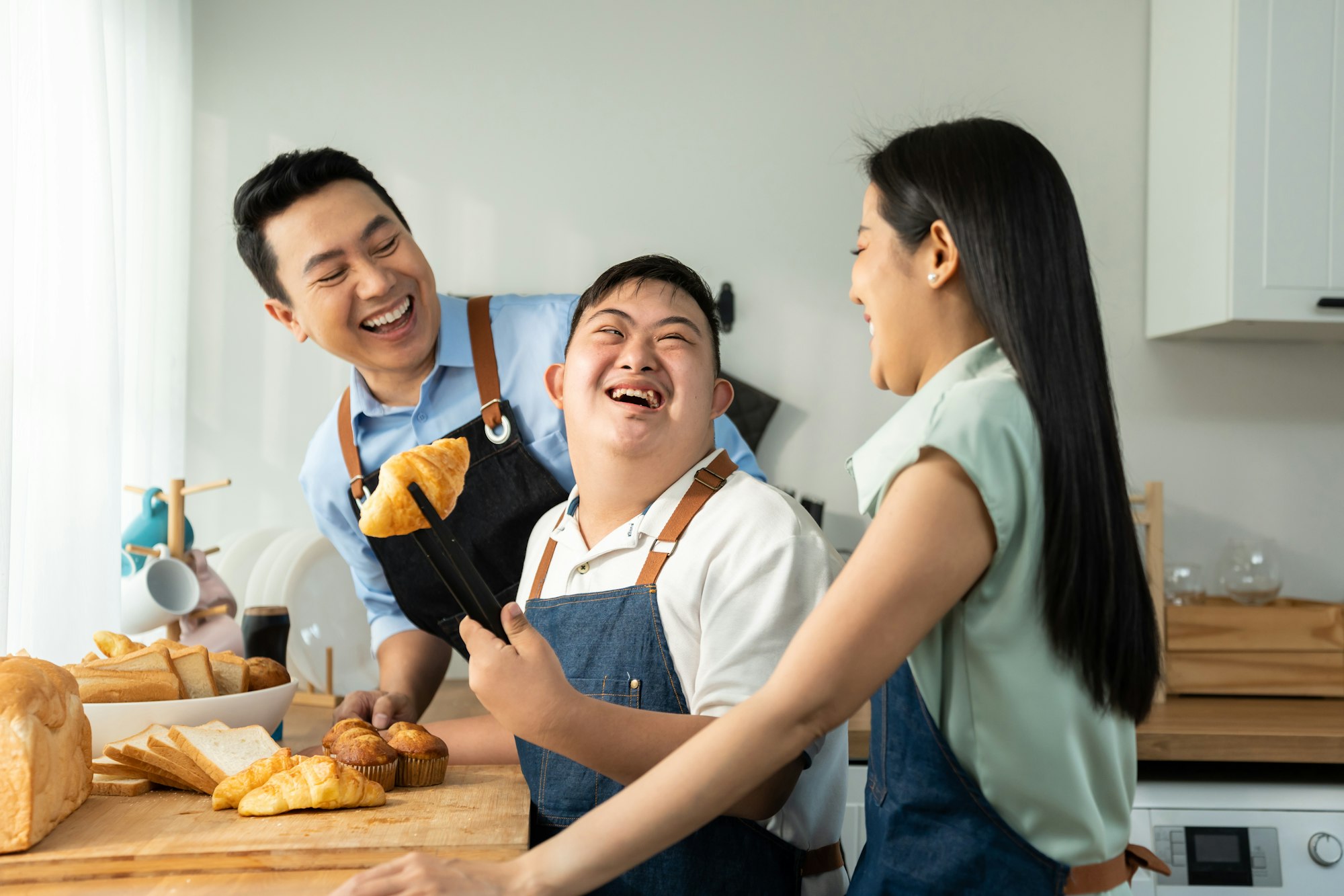 Asian happy family, mature parents baking bakery with son in kitchen.