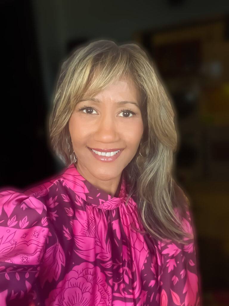 Marisol Dátiz Stevens in pink blouse - CEO & President Coquí Destination and Relocation Services, Puerto Rico-based relocation assistance company