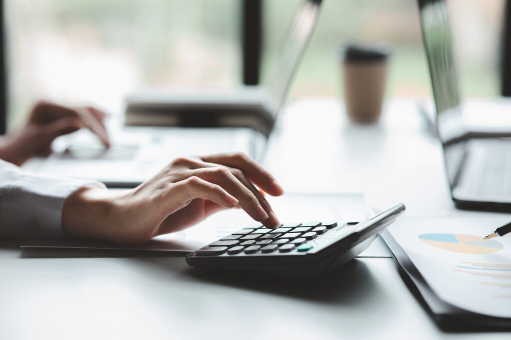 A female financier is reviewing company financial documents.