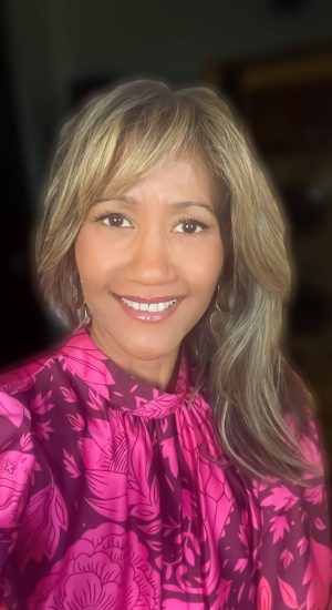 Marisol Dátiz Stevens in pink blouse - CEO & President Coquí Destination and Relocation Services, Puerto Rico-based relocation assistance company